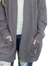 Women's chunky cable knit open front cardigan with front pockets in dark gray. Cozy fall sweater perfect for layering with jeans, dresses, leggings, and boots.