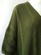 Women's chunky cable knit open front cardigan with front pockets in green. Cozy fall sweater perfect for layering with jeans, dresses, leggings, and boots.