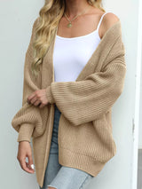 Women's oversized khaki chunky knit open front cardigan with long balloon sleeves, soft textured sweater perfect for fall layering with jeans.