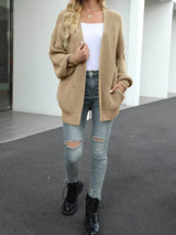 Women's oversized khaki chunky knit open front cardigan with long balloon sleeves, soft textured sweater perfect for fall layering with jeans.