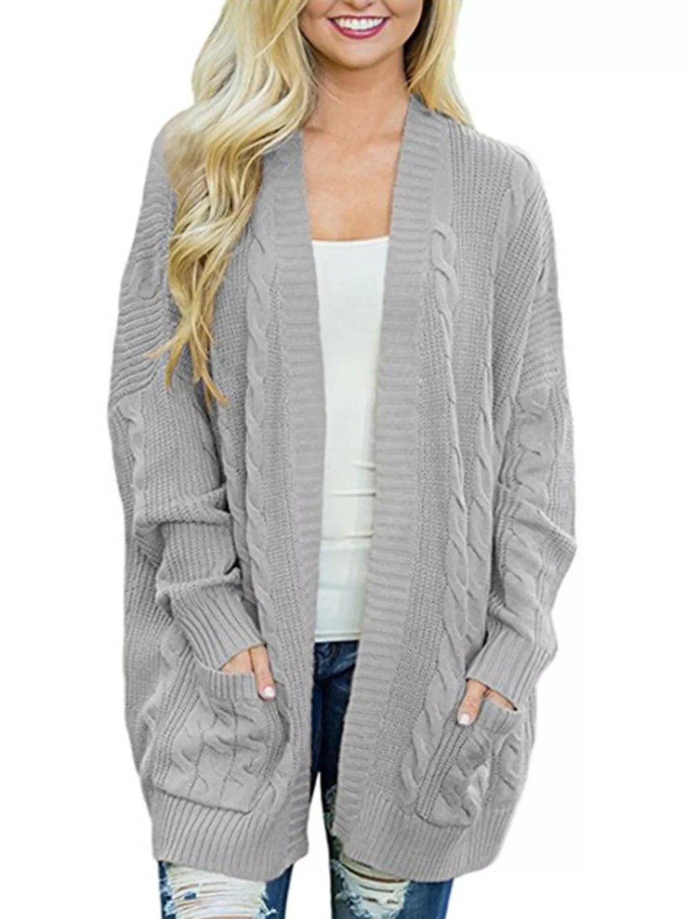 Women's chunky cable knit open front cardigan with front pockets in light gray. Cozy fall sweater perfect for layering with jeans, dresses, leggings, and boots.