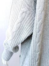 Women's chunky cable knit open front cardigan with front pockets in light gray. Cozy fall sweater perfect for layering with jeans, dresses, leggings, and boots.