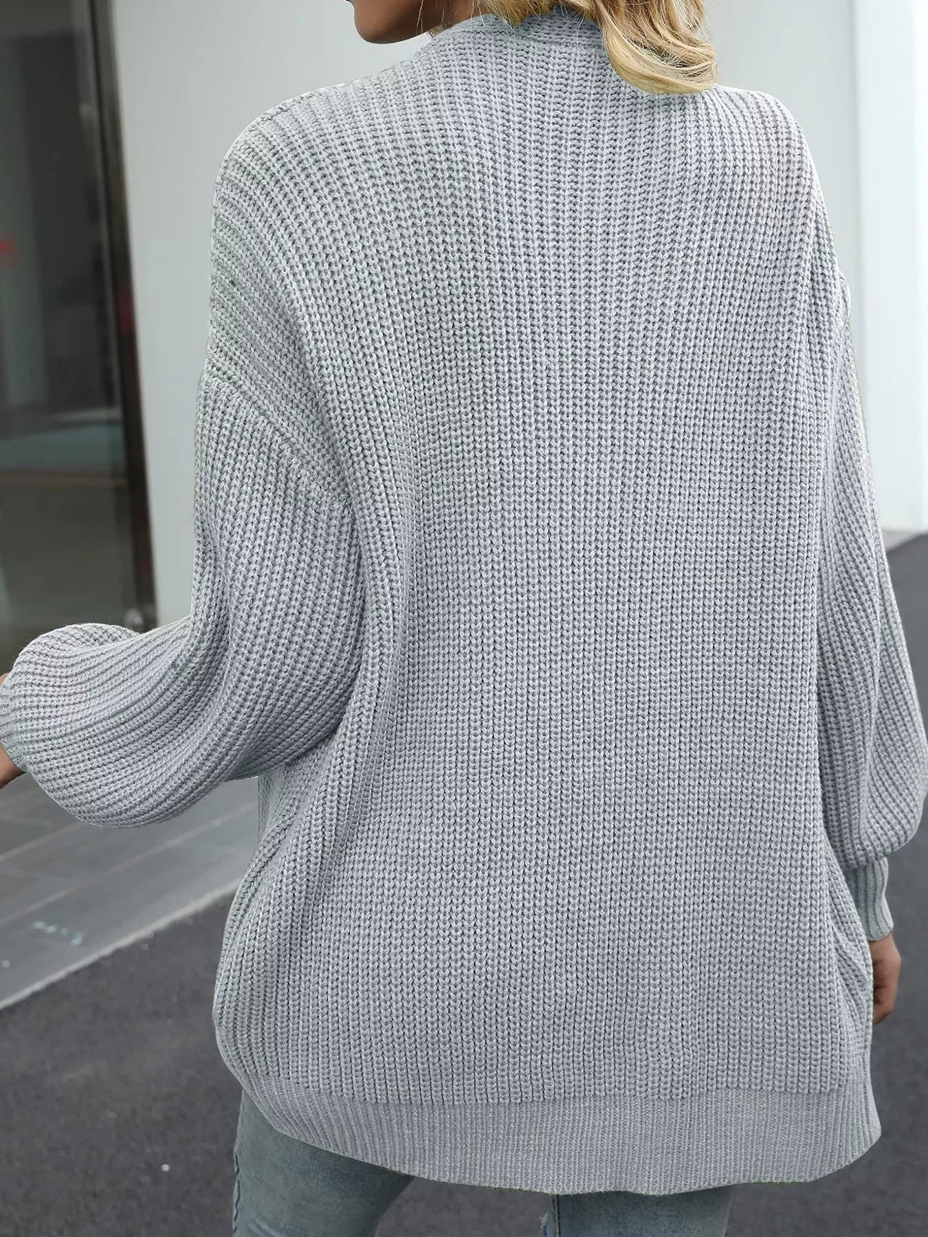 Women's oversized light gray chunky knit open front cardigan with long balloon sleeves, soft textured sweater perfect for fall layering with jeans.