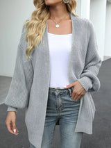 Women's oversized light gray chunky knit open front cardigan with long balloon sleeves, soft textured sweater perfect for fall layering with jeans.