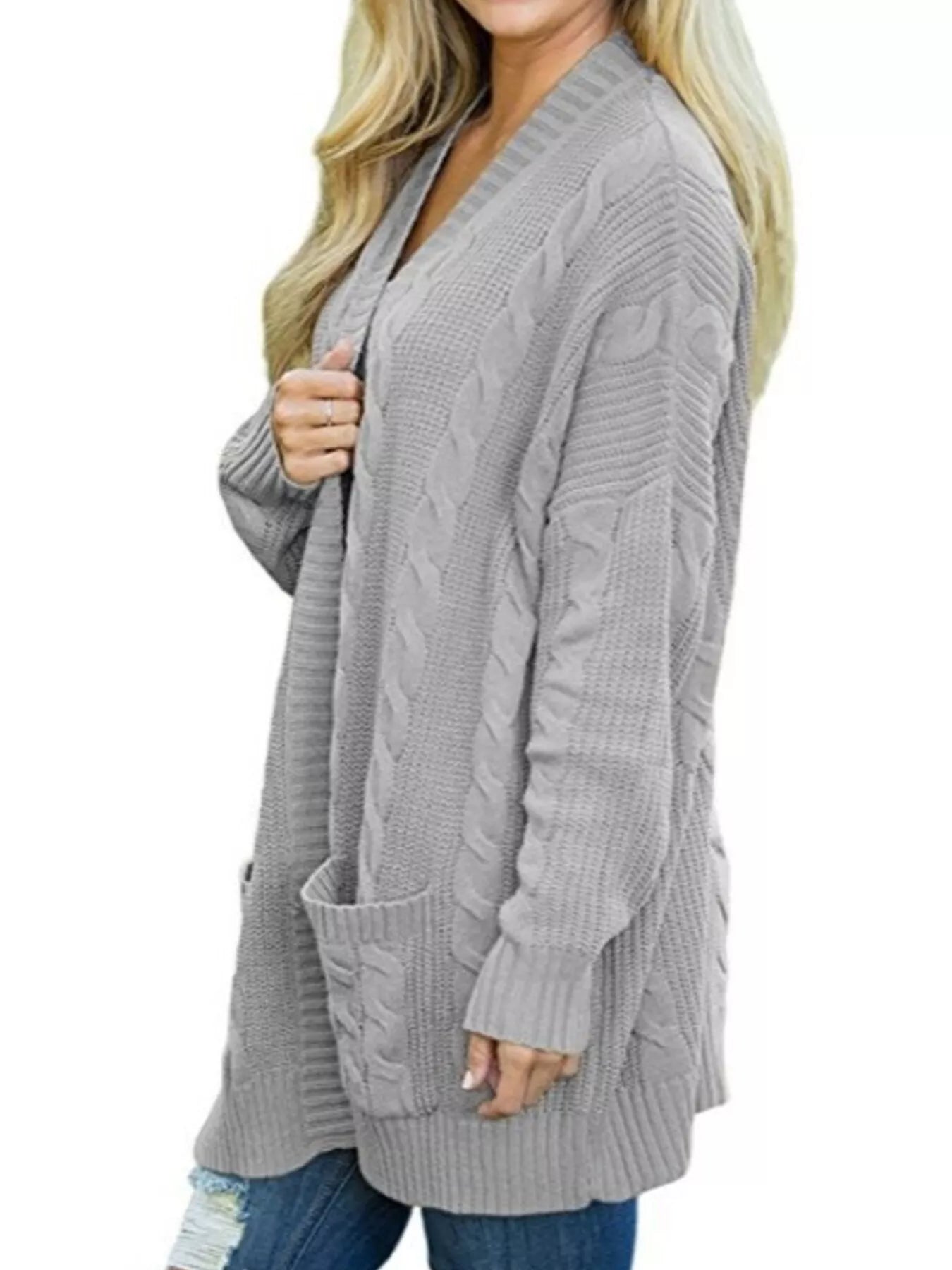 Women's chunky cable knit open front cardigan with front pockets in light gray. Cozy fall sweater perfect for layering with jeans, dresses, leggings, and boots.