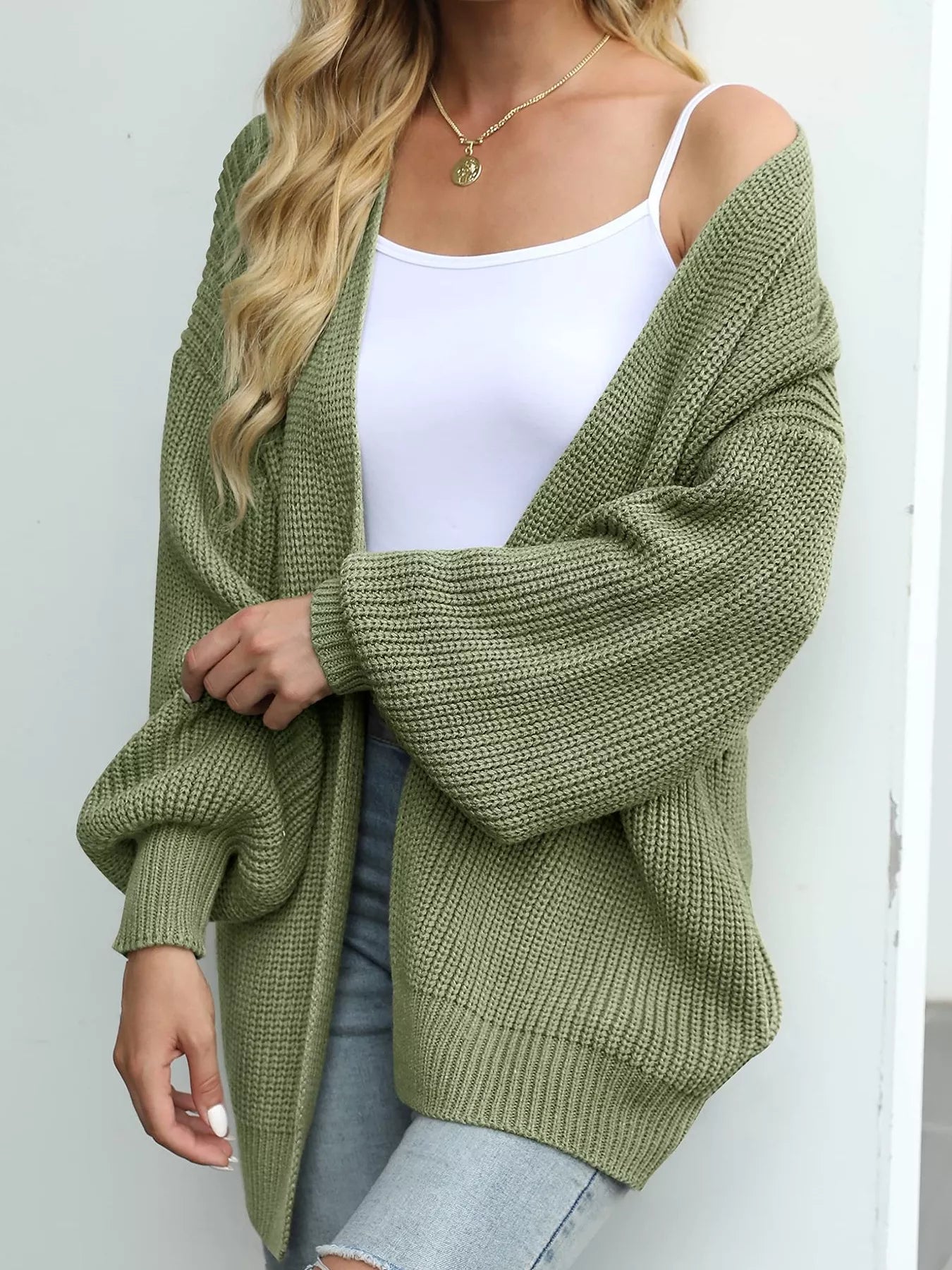 Women's oversized matcha green chunky knit open front cardigan with long balloon sleeves, soft textured sweater perfect for fall layering with jeans.
