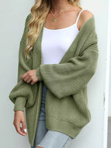 Women's oversized matcha green chunky knit open front cardigan with long balloon sleeves, soft textured sweater perfect for fall layering with jeans.