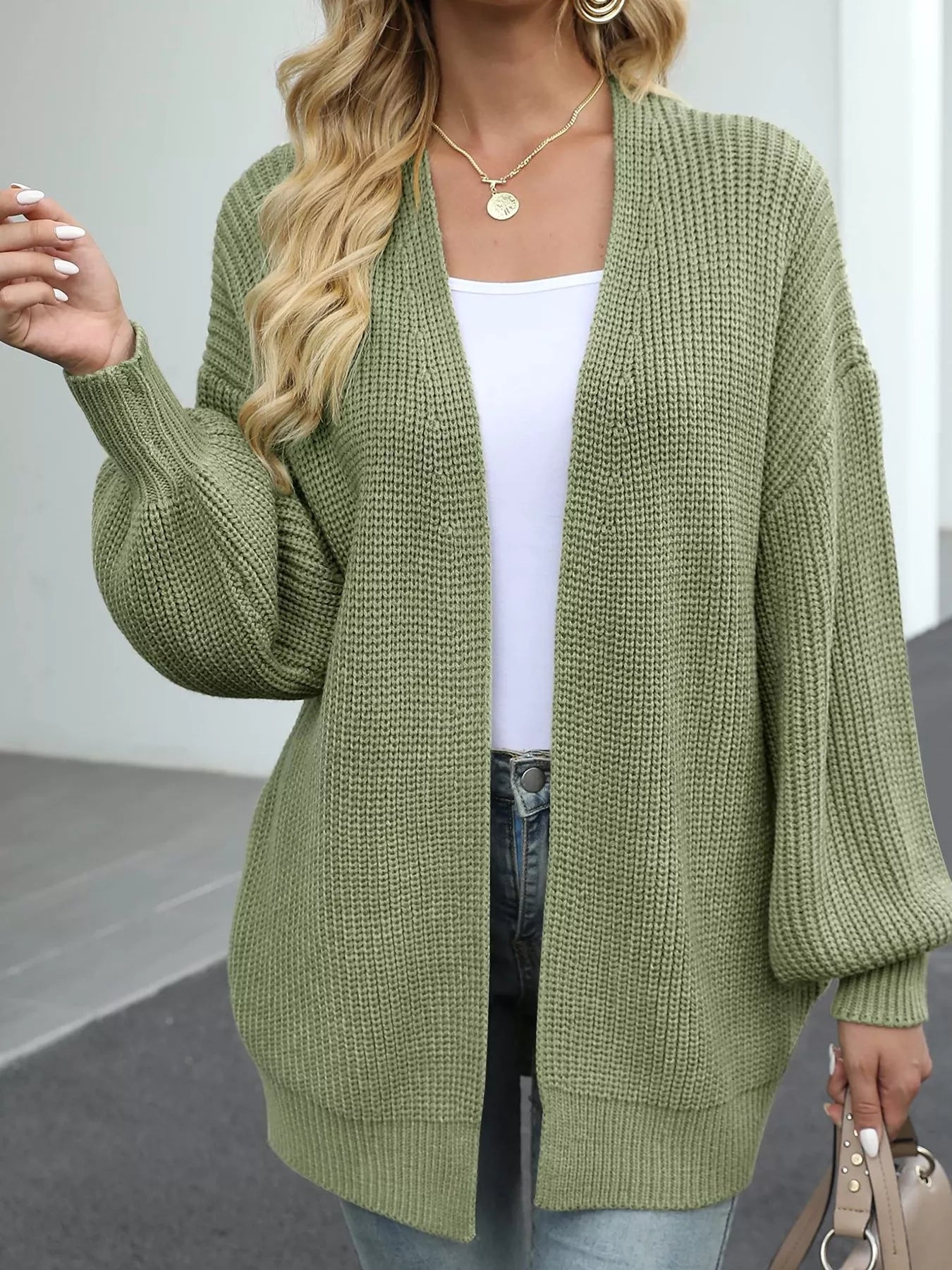 Women's oversized matcha green chunky knit open front cardigan with long balloon sleeves, soft textured sweater perfect for fall layering with jeans.