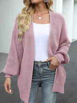 Women's oversized pink chunky knit open front cardigan with long balloon sleeves, soft textured sweater perfect for fall layering with jeans.