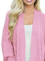 Women's chunky cable knit open front cardigan with front pockets in pink. Cozy fall sweater perfect for layering with jeans, dresses, leggings, and boots.