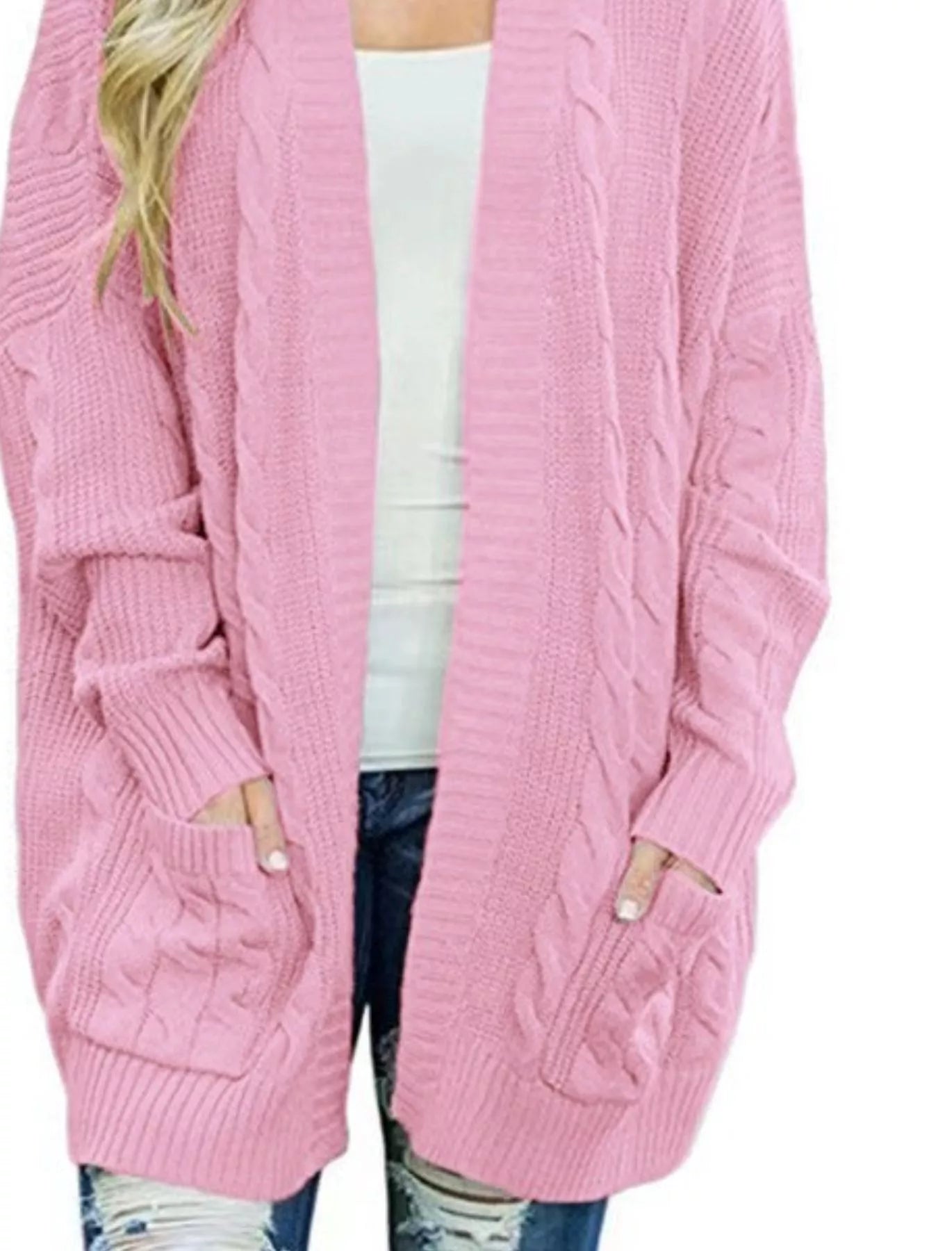 Women's chunky cable knit open front cardigan with front pockets in pink. Cozy fall sweater perfect for layering with jeans, dresses, leggings, and boots.