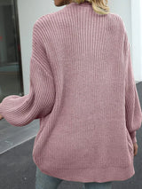 Women's oversized pink chunky knit open front cardigan with long balloon sleeves, soft textured sweater perfect for fall layering with jeans.