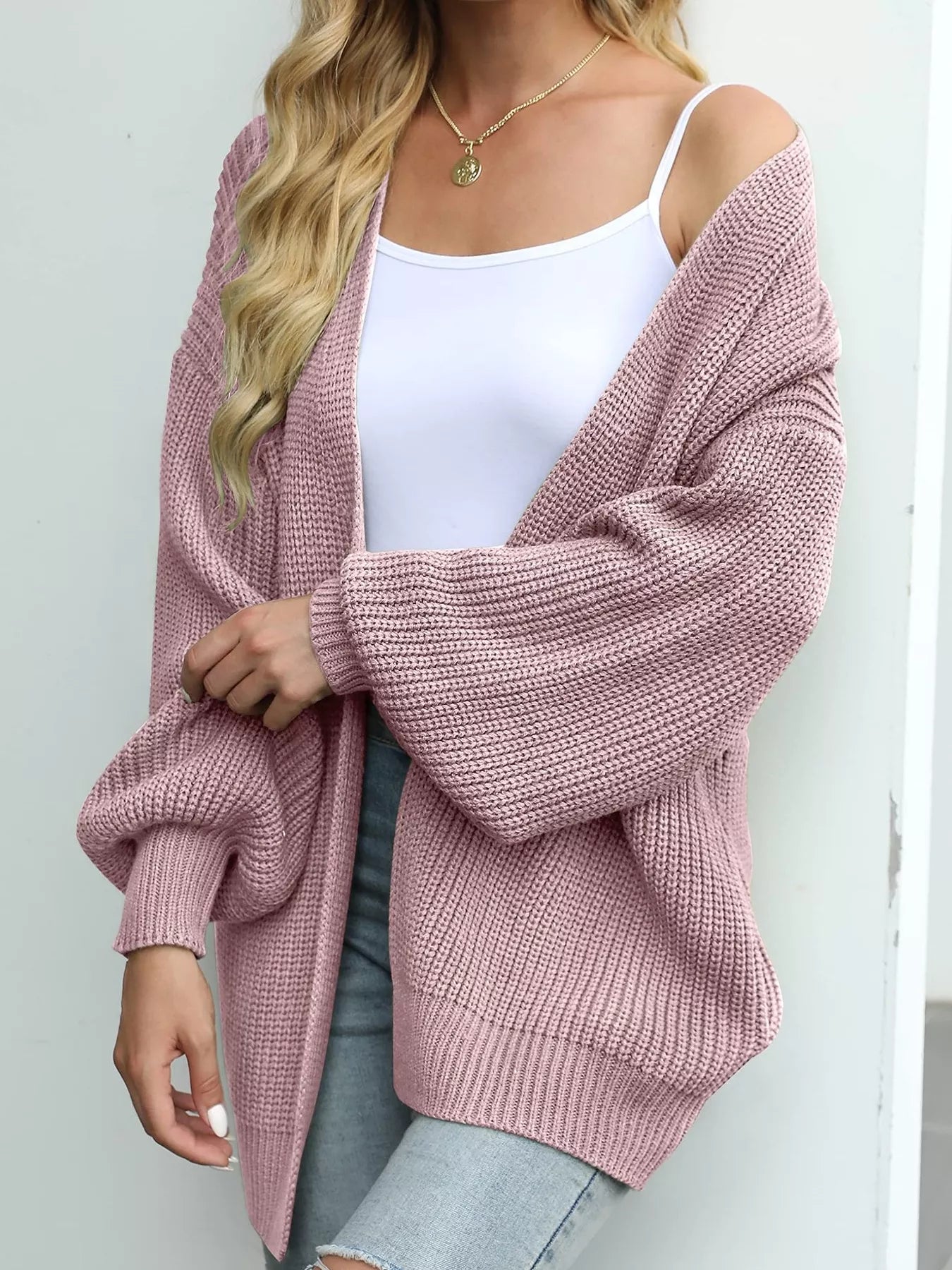 Women's oversized Pink chunky knit open front cardigan with long balloon sleeves, soft textured sweater perfect for fall layering with jeans.