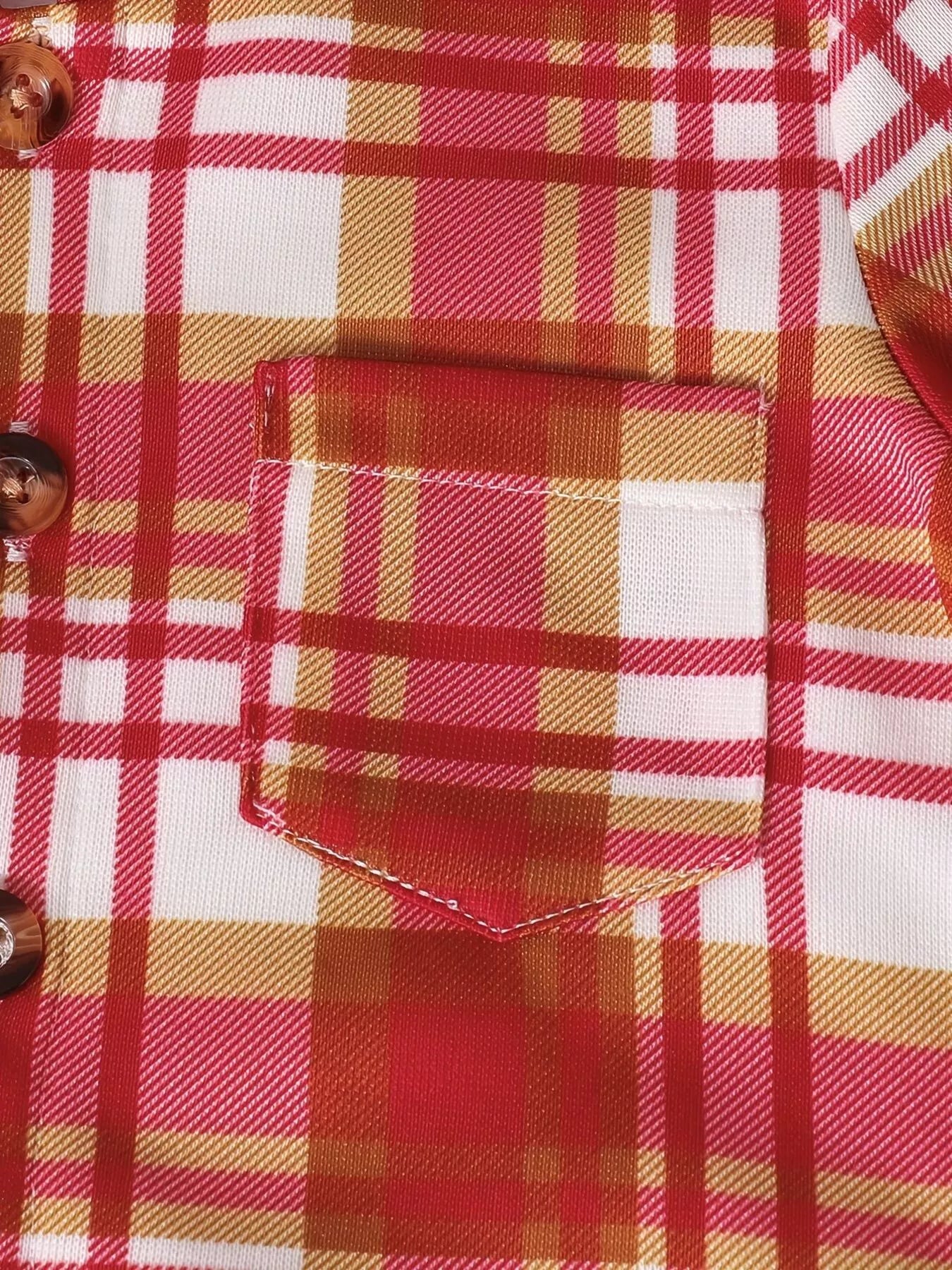 Close-up of pocket of children's red, cream and gold plaid hooded top with coordinating solid red jogger-style pants, part of a three-piece boys' outfit.