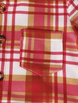 Close-up of pocket of children's red, cream and gold plaid hooded top with coordinating solid red jogger-style pants, part of a three-piece boys' outfit.