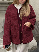 Women's burgundy contrast button up sherpa jacket with pockets and long sleeves.