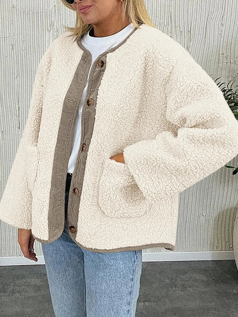 Women's cream contrast button up sherpa jacket with pockets and long sleeves.