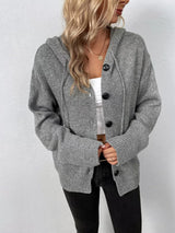 Women's gray cozy knit hooded button-down cardigan with black buttons, soft lightweight sweater paired with black pants for casual fall style.