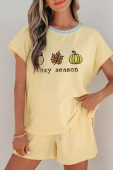 Woman wearing a Cozy Season embroidered ribbed two-piece short set featuring a relaxed fit, drawstring shorts, and fall-inspired embroidered graphics.