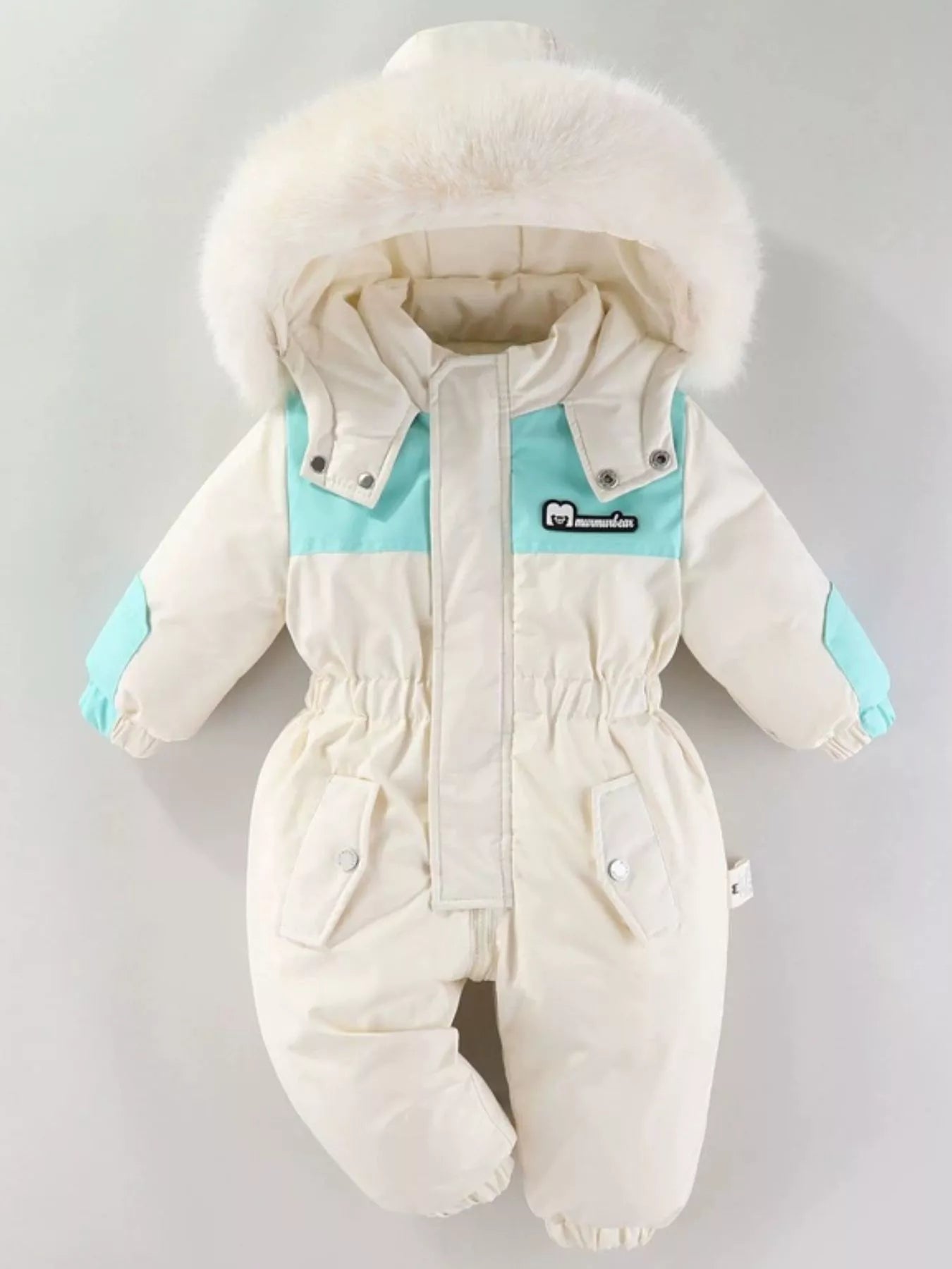 Children's cream one-piece winter snowsuit featuring a fluffy white faux fur-trimmed hood, rust-colored accents, elasticized waist, and front pockets.