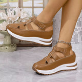 Brown sandals with white soles worn by a person, with a decorative background.