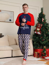 Dad wearing matching Christmas pajamas with navy tops, red raglan sleeves, festive Christmas tree lettering, and coordinating printed pants.