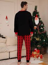 Dad modeling matching Christmas Crew pajama sets with festive black graphic tops and red and black plaid pants.