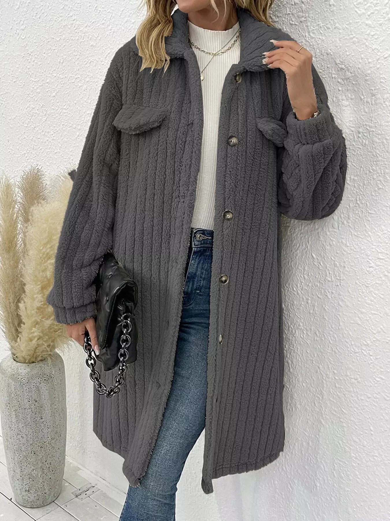 Women’s dark gray textured button-down longline outerwear with pockets styled with a cream top and jeans