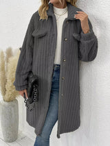 Women’s dark gray textured button-down longline outerwear with pockets styled with a cream top and jeans