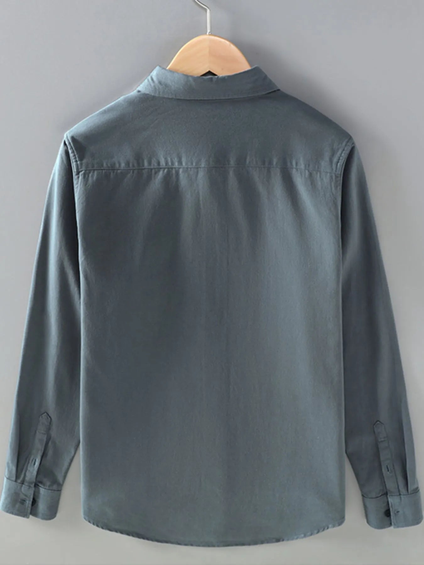 Men’s dark gray plus size button-up long sleeve shirt with multiple pockets, shown layered over a white T-shirt.