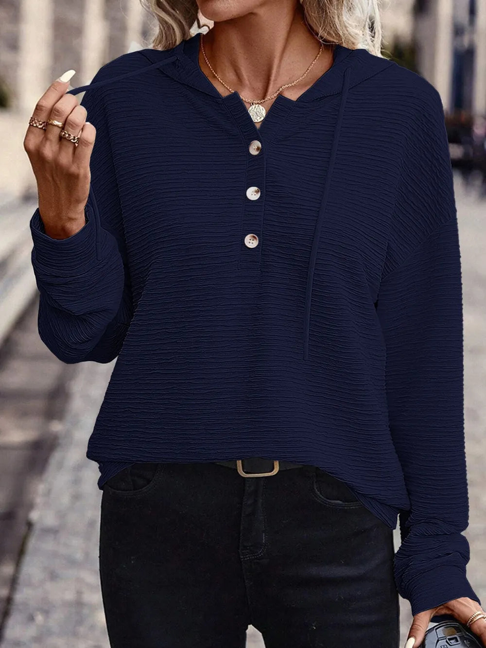 Woman wearing a dark navy textured drawstring quarter-button long sleeve hoodie paired with black jeans, perfect for casual fall outfits, available in 10 colors and sizes Small–2XL.