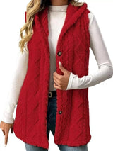 Woman wearing a deep red hooded sherpa vest coat over a white long-sleeve top with blue jeans for a cozy fall and winter outfit.
