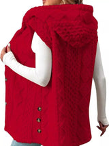 Woman wearing a deep red hooded sherpa vest coat over a white long-sleeve top with blue jeans for a cozy fall and winter outfit.
