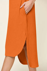 Women's tangerine round neck short sleeve midi dress with side slit and relaxed fit, available in sizes Small–3XL.