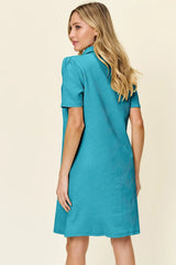 Woman wearing a pastel blue dress against a beige background