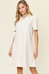 Woman wearing a white dress against a beige background