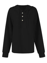 Woman wearing a black textured drawstring quarter-button long sleeve hoodie paired with black jeans, perfect for casual fall outfits, available in 10 colors and sizes Small–2XL.