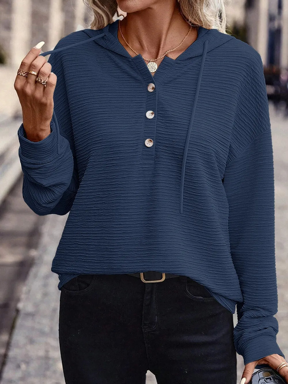 Woman wearing a dark blue textured drawstring quarter-button long sleeve hoodie paired with black jeans, perfect for casual fall outfits, available in 10 colors and sizes Small–2XL.