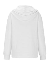 Woman wearing a white textured drawstring quarter-button long sleeve hoodie paired with black jeans, perfect for casual fall outfits, available in 10 colors and sizes Small–2XL.