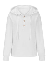 Woman wearing a white textured drawstring quarter-button long sleeve hoodie paired with black jeans, perfect for casual fall outfits, available in 10 colors and sizes Small–2XL.