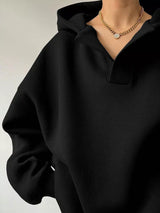 Women's oversized dropped shoulder hoodie sweatshirt in black with long sleeves and relaxed fit, perfect for casual fall outfits, available in 11 colors and sizes Small–2XL.
