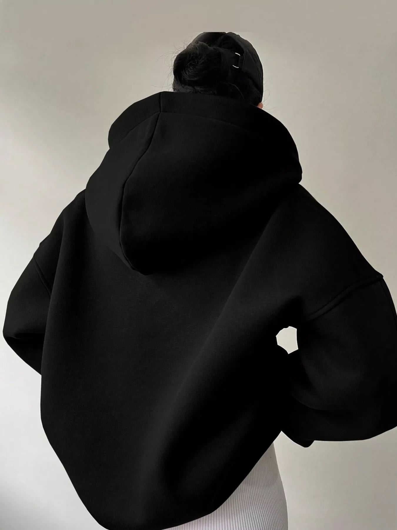 Women's oversized dropped shoulder hoodie sweatshirt in black with long sleeves and relaxed fit, perfect for casual fall outfits, available in 11 colors and sizes Small–2XL.