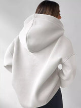 Women's oversized dropped shoulder hoodie sweatshirt in white with long sleeves and relaxed fit, perfect for casual fall outfits, available in 11 colors and sizes Small–2XL.