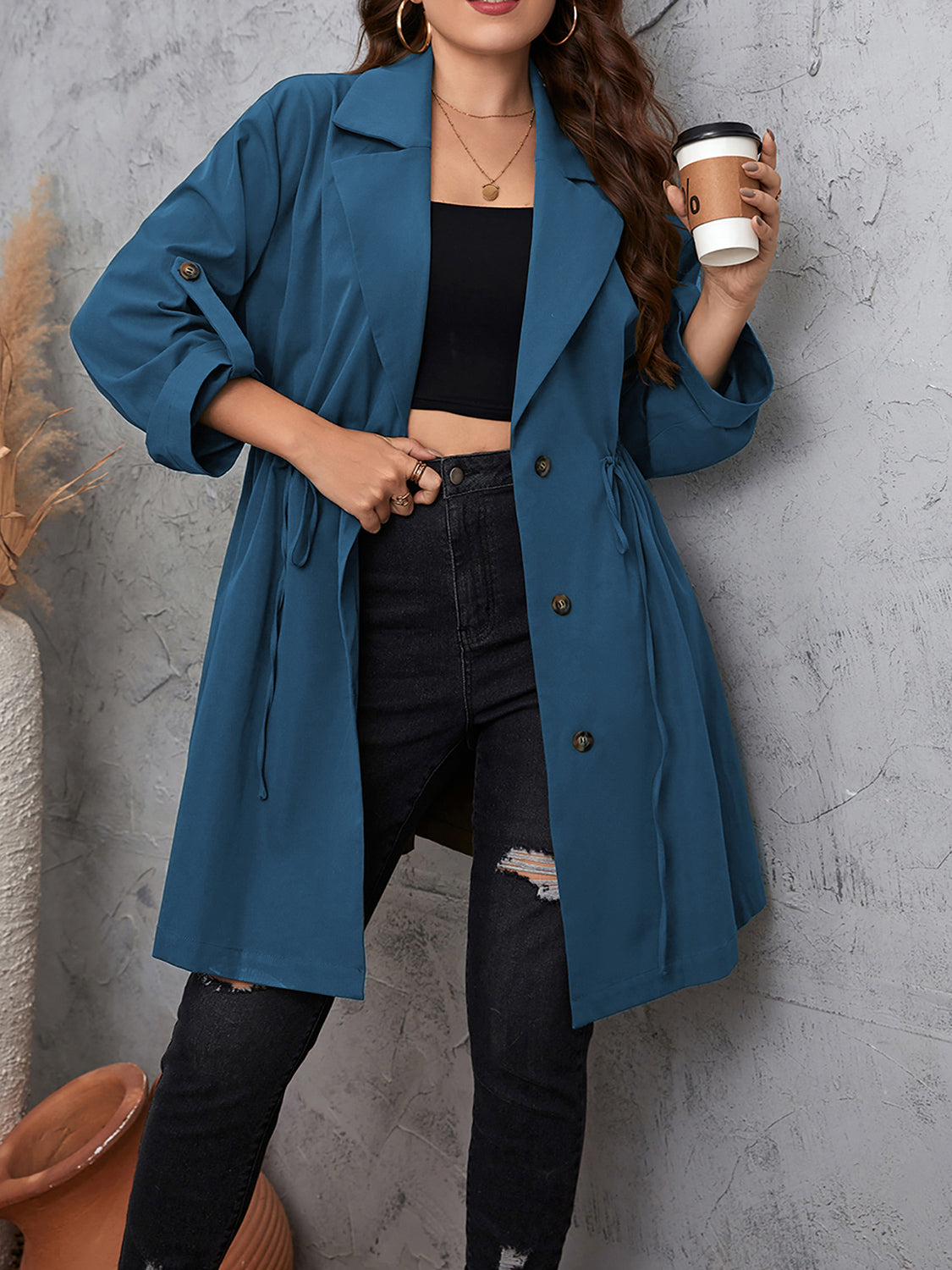 Woman wearing the Honey Plus Size Lapel Collar Drawstring Roll-Tab Sleeve Trench Coat in dusty blue with black denim and a black top, lightweight plus size fall trench coat from Chic Mystik Boutique.