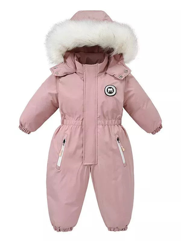 Children's dusty pink one-piece winter snowsuit featuring a fluffy white faux fur-trimmed hood, rust-colored accents, elasticized waist, and front pockets.