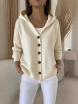 Women's apricot button-up knit cardigan with hood and front pockets, long sleeve lightweight sweater styled with white pants, available in sizes Small–5XL.