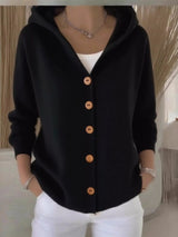 Women's black button-up knit cardigan with hood and front pockets, long sleeve lightweight sweater styled with white pants, available in sizes Small–5XL.