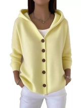 Women's light-yellow button-up knit cardigan with hood and front pockets, long sleeve lightweight sweater styled with white pants, available in sizes Small–5XL.