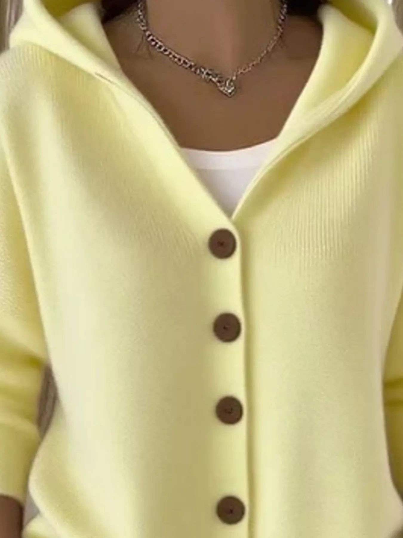 Women's light-yellow button-up knit cardigan with hood and front pockets, long sleeve lightweight sweater styled with white pants, available in sizes Small–5XL.