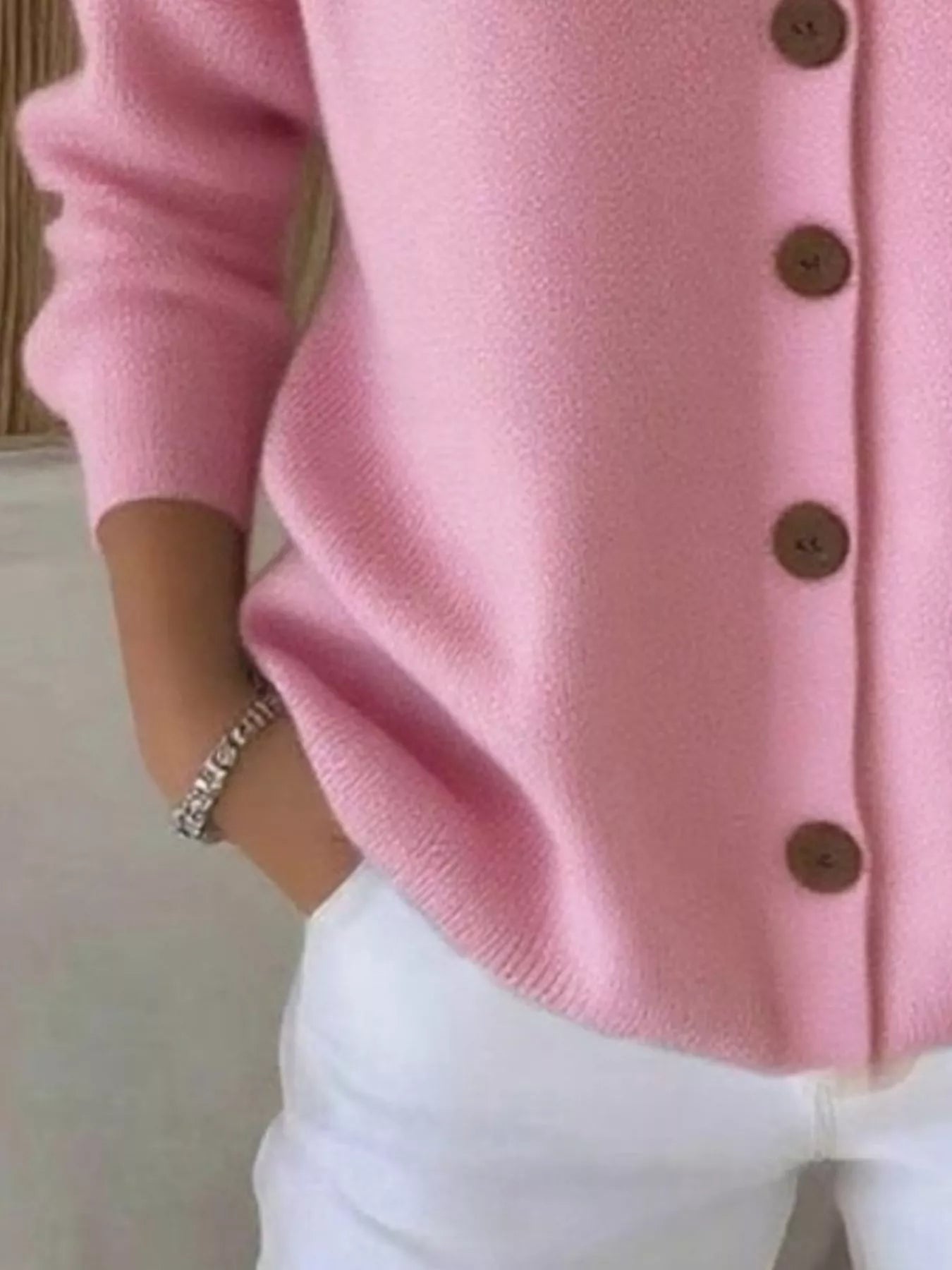 Women's pink button-up knit cardigan with hood and front pockets, long sleeve lightweight sweater styled with white pants, available in sizes Small–5XL.